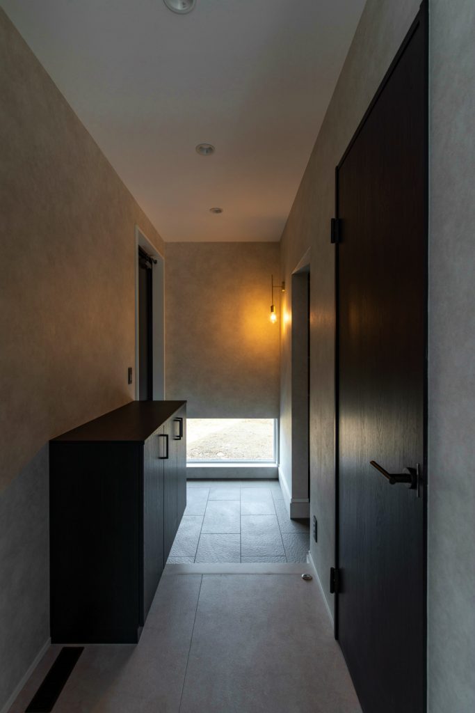 地窓とブラケット照明のある玄関